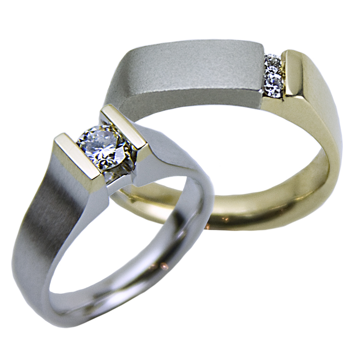 “Straight Channel” ladies ring - Round Brilliant cut Diamond, .39cts, set in 18k yellow gold and 14k white gold. “Diamond Offset” gents ring - Two round cut Diamonds, .11cts, set in 18k yellow and white gold.