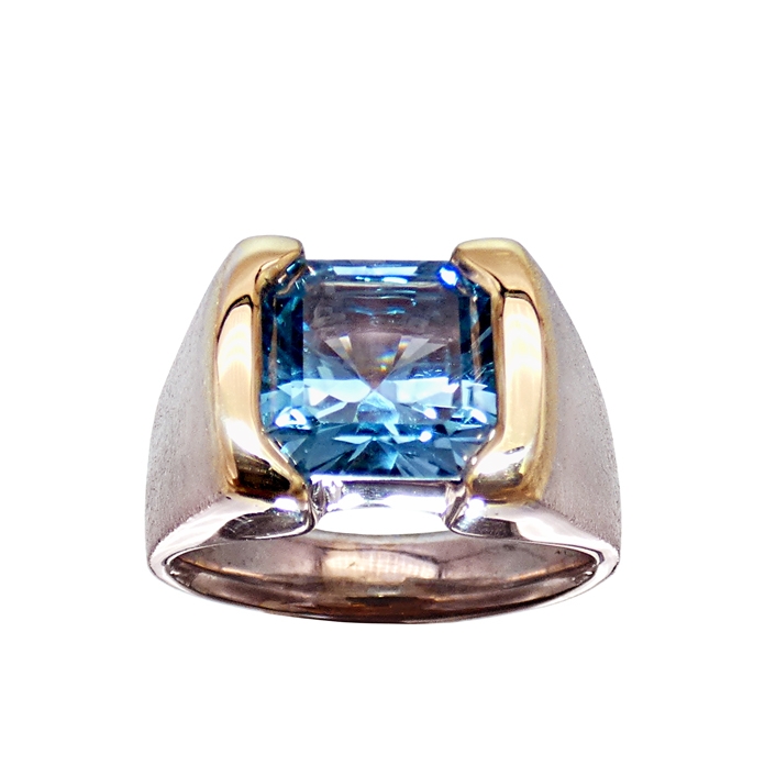 Item# KRYW-BT-3609 Designer: Grace Koorey Stone: Square Emerald-cut Blue Topaz = 6.0 cts, partial channel set men’s ring Setting: 18 KYG / 14 KWG = 14.5 dwt