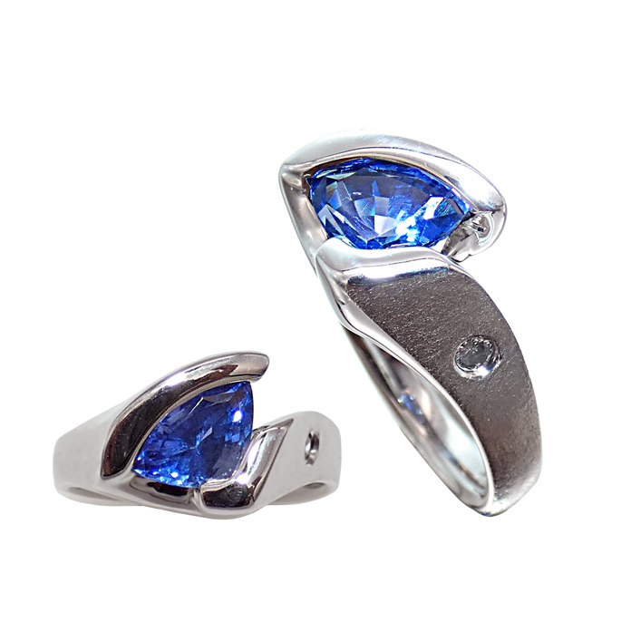 KC Custom Design ladies ring with modified triangle sapphire = 2.18 cts and round diamond = .04 cts SI G in 14KWG = 5.4 dwt. Item# KRW-S-D-1292